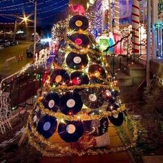 a christmas tree decorated with records and lights