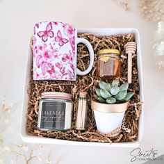 a gift box with candles, tea and succulents