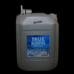 a gallon of liquid sitting on top of a black surface with the words true north printed on it