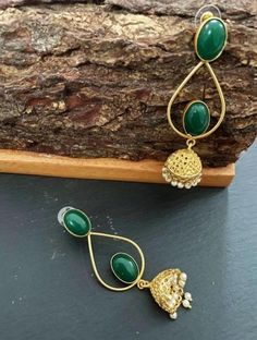 These are purely handmade jumiki earrings in Gold . A gold jumki with emerald green stones . A very unique hand crafted earrings  Available in 1. Ruby red stone & gold jhumka/ jumki 2. Emerald green stone & gold jhumki / jumkha earrings  These are an authentic Indian traditional earrings that could be worn by both traditional and an western attire. This Unique jewellery is designed and crafted at Abi CreatioNzs Abi CreatioNzs is the place for anyone who Is in lookout for a latest trend with an e Handmade Green Bohemian Jhumkas, Brass Dangle Jhumkas For Festivals, Green Jhumkas With Stone Work, Traditional Green Brass Earrings, Green Bohemian Dangle Jhumkas, Green Chandbalis With Latkans For Party, Elegant Green Earrings For Eid, Festive Green Round Jhumkas, Festive Green Bohemian Earrings