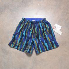 "Great pair of vintage swim shorts by Speedo. Drawstring waist. Fully lined. Excellent vintage condition - like new with tags. Please see actual measurements below.  Waist: 38-42\" Inseam: 6\" Outseam: 16\" If you would like to see additional photos or have any other questions, please do not hesitate to ask, and thanks for looking! Shipping disclaimer: All domestic orders under 16oz ship USPS Ground Advantage. All domestic orders over 16oz ship USPS priority mail. All international orders under Retro Blue Bottoms For Poolside, Retro Blue Swimming Bottoms, Retro Blue Swim Bottoms, Vintage Blue Swimwear For The Beach, Vintage Blue Swimwear For Swimming, Vintage Blue Swimwear For Summer, Retro Swim Trunks With Built-in Shorts For Beach, Blue Fitted Athletic Shorts For Beachwear, Vintage Athletic Shorts For Summer