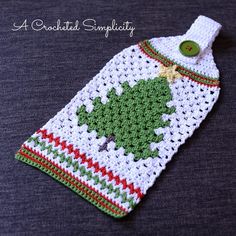 a crocheted christmas stocking with a green tree on it