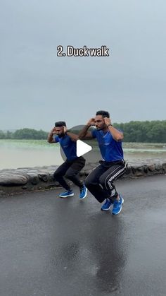 two men in blue shirts and black pants doing dance moves on the street with text reading 2 duckwalk