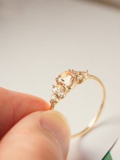 A close-up of a pale blush pink morganite engagement ring with white sapphire accents, symbolizing love and commitment Pink Morganite Engagement Ring, Blushing Bride, White Sapphire Ring, Morganite Engagement, Pink Morganite, Tea Rose, Morganite Engagement Ring, Solid Gold Rings, Tea Roses