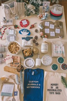 a table topped with lots of personal items and christmas tree decorations on top of it