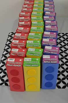 a table topped with lots of different colored boxes on top of a black and white cloth