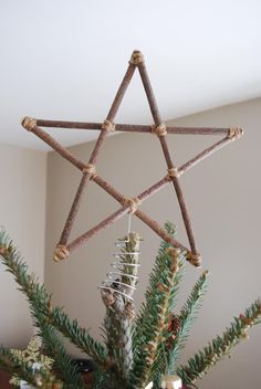 a star ornament hanging from a christmas tree