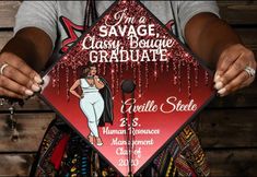 a woman holding up a graduation cap with the words i'm a savage, classy bougie graduate on it