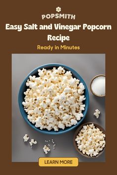 popcorn in a blue bowl next to two spoons