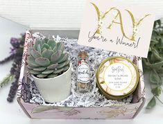 a gift box containing an assortment of condiments and a sign that says congrats