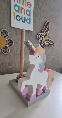 a little and loud unicorn sculpture on a table