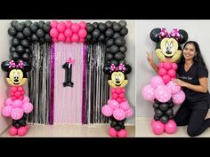 the balloon arch is decorated with minnie mouse balloons