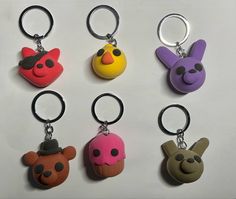 six different colored key chains with cartoon characters on them