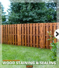 wood staining and sealing on a fence in front of a green yard with trees