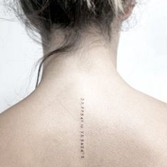 the back of a woman's neck with words written in cursive writing