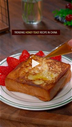 a plate with french toast and strawberries on it