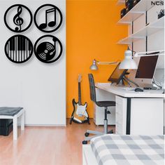 a room with a guitar, keyboard and musical notes on the wall