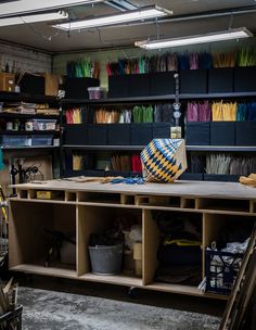 a room filled with lots of crafting supplies and storage containers on top of shelves