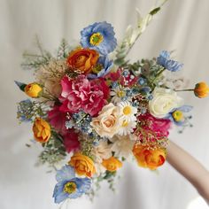 a woman holding a bouquet of flowers in her hand on a white background with blue and red colors