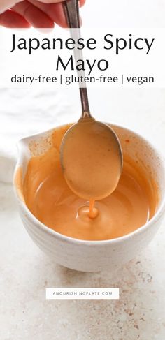 a spoon in a bowl filled with sauce and the words japanese spicy mayo above it