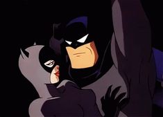 batman and catwoman hugging in the dark