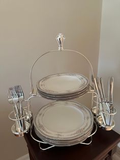 a stack of silverware sitting on top of a wooden table