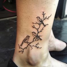 two birds sitting on a branch tattoo on the ankle, with dots in the background