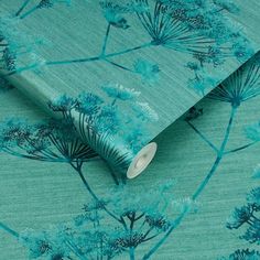 a wallpaper with blue flowers on it and a roll of tape next to it