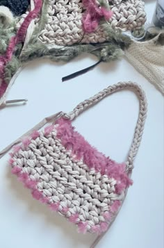 two crocheted purses sitting next to each other on a white counter top