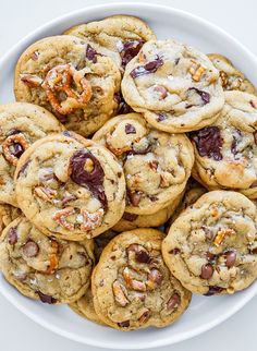 a plate full of cookies with nuts and raisins on top, ready to be eaten