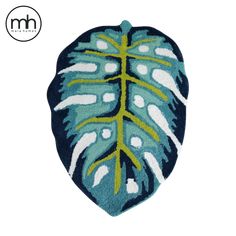 a blue and green leaf shaped rug