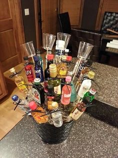 a basket filled with bottles and glasses on top of a counter