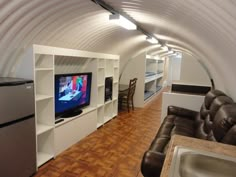 a living room filled with furniture and a flat screen tv