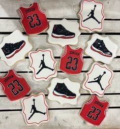 decorated cookies are arranged in the shape of basketball shoes and sneakers with numbers on them