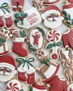 decorated christmas cookies are displayed on a table