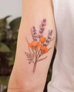 an orange flower tattoo on the left arm