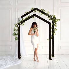 a woman in a white dress holding flowers