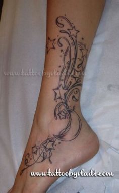 a woman's foot with an artistic tattoo design on the bottom of her leg