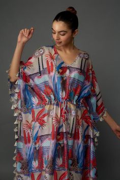 Red and multicolored silk mul kaftan with tropical print and tassel details. - Aza Fashions Multicolor Tassel Kaftan For Vacation, Multicolor Tasseled Kaftan For Vacation, Spring Multicolor Kaftan With Tassels, Multicolor Vacation Kaftan With Tassels, Beach Kaftan With Kimono Sleeves And Tassels, Multicolor Spring Kaftan With Back Tassel Tie-up, Multicolor Vacation Dress With Back Tassel Tie-up, Multicolor Kaftan With Back Tassel Tie-up For Summer, V-neck Kaftan With Tassels For Vacation