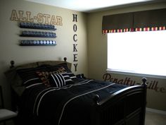 a bed room with a neatly made bed next to a window and wall hangings