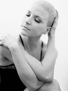 black and white photograph of a woman with her hands on her head