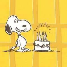 a cartoon dog sitting in front of a birthday cake with lit candles on it's side