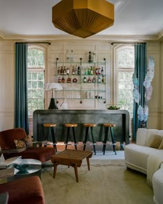 a living room filled with furniture and a bar in the middle of it's walls