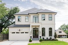 a white house with black trim and windows