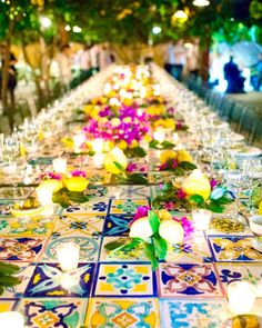 the long table is decorated with flowers and candles