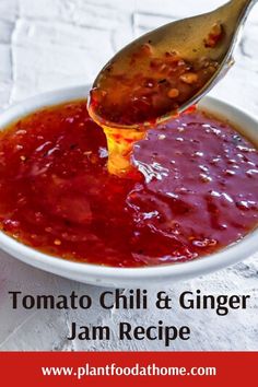 tomato chili and ginger jam recipe in a white bowl with a spoon scooping out