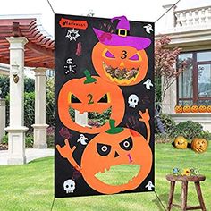 an outdoor halloween yard decoration with pumpkins and jack - o'- lantern faces