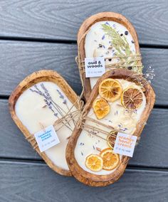 two slices of bread sitting on top of each other next to some dried oranges