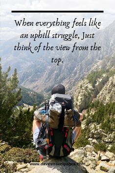 a person sitting on top of a mountain with a backpack