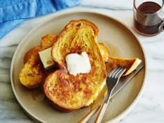 a plate topped with french toast and butter